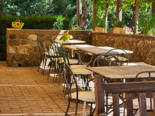 Empty chairs and tables on an outdoor seating area