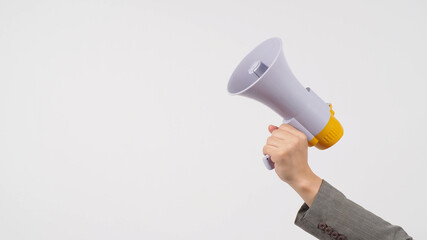 Hand is hold megaphone and wear grey suit on white background.