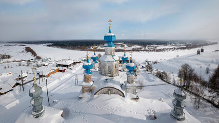 View of the wonderful provincial town of Cherdyn (Russia) and the frozen river in winter. Close-up...