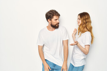 cheerful young couple in white t-shirts embrace friendship lifestyle