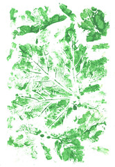 Colorful green background painted by brush with imprinted leaves pattern. Gouache painting.