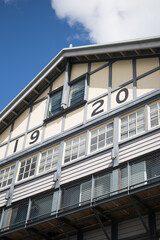 Fototapeta premium historic facade finger wharf building timber 1920 windows blue sky looking up old 