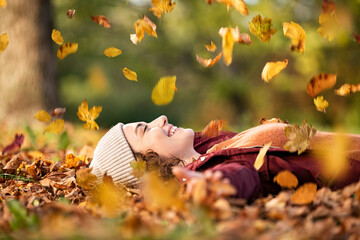 Happy young woman enjoy the autumn season at park