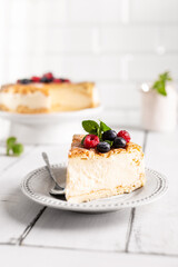 Vanilla cheesecake decorated with berries on a plate
