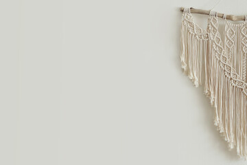 Beautiful boho macrame on wall panel. tapestry in the style of Boho made of cotton threads in natural color using the macrame technique for home decor and wedding decoration.