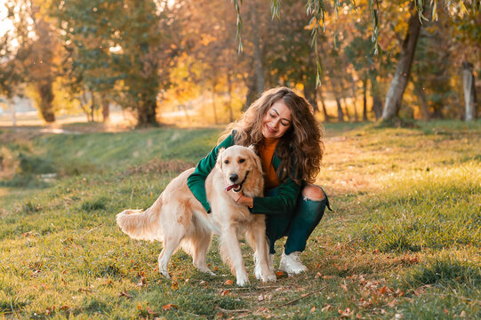White Retriever dog receives a reward for obedience outdoors