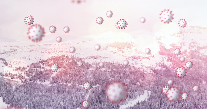 Image of covid 19 cells floating over winter scenery in background