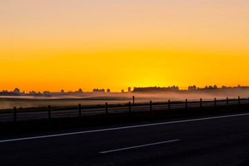 city. sunrise sun. expressway. fog. close-up. there is a tinting.