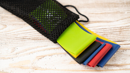 Top view of resistance bands on table. Resistance band. The colorful fitness band set in bag