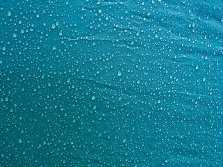 Water drops on waterproof membrane fabric. Morning dew on tent.