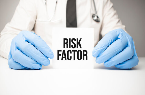 White sticker with text Risk Factor in doctor's hands with a stethoscope