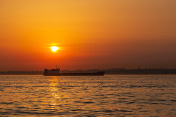Obraz premium Cargo ship in the Bosporus on a sunset. Istanbul