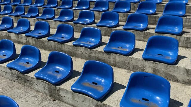 Blue empty plastic chair seats of sport stadium.