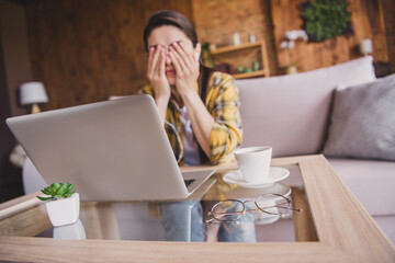 Photo of young tired unhappy woman cover eyes face hands bad mood laptop work indoors inside house home apartment