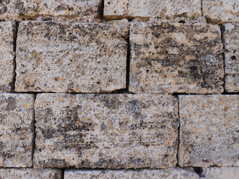Detail of the old stone wall of an ancient Romanesque church