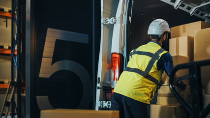 Handsome Latin Male Worker Wearing Hard Hat Loads Cardboard Boxes into Delivery Truck. Delivering...