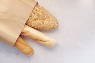 whole grain baked bread in a shopping bag on table 