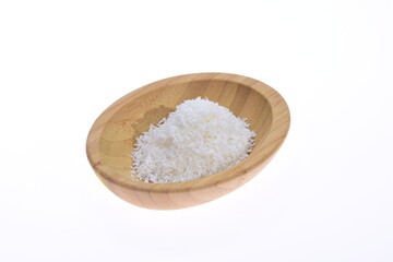 Fototapeta na wymiar Coconut shavings in a wooden bowl against a white background. Food.