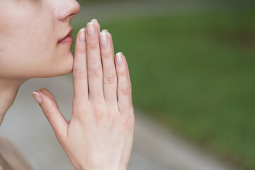 Portrait of a spiritual, young and attractive blonde girl. Lady pray to God with hope and faith