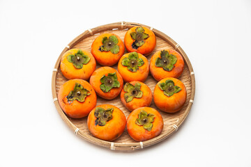 A pile of orange persimmons isolated on white background