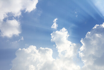 Beautiful white clouds and sunbeam on the blue sky background