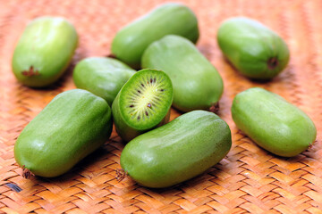 mini kiwi baby fruit (actinidia arguta) on white background 