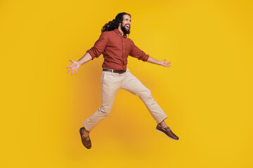 Fototapeta na wymiar Portrait of cheerful funky guy jump enjoy have fun on yellow background