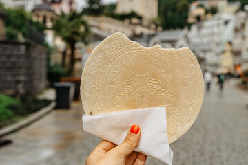 Famous Carlsbad wafer,CZ: lazenske oplatky, originated in 1867. Woman hand holding traditional Czech sweet cookie snack made in Karlovy Vary, famous spa city on UNESCO list.Tasty food background - obrazy, fototapety, plakaty
