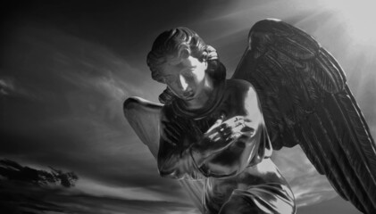 Beautiful angel against dark sky. Religion, faith, eternity concept. Black and white image.