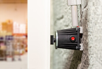 Close up electromagnetic lock mounted on an aluminum fire door to restrict access to warehouse or...