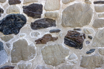Fragment of the wall from natural stone of various shape
