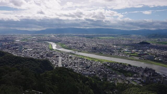 Gifu city and the Nagara River, seen from Gifu Castle. Pan establishing shot