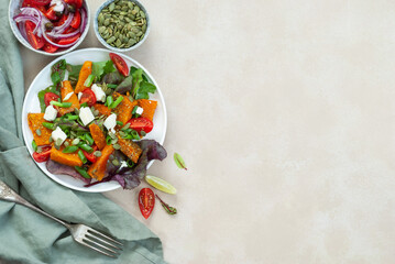 Salad with pumpkin, cheese, mini tomatoes and pumpkin seeds. coppy spice