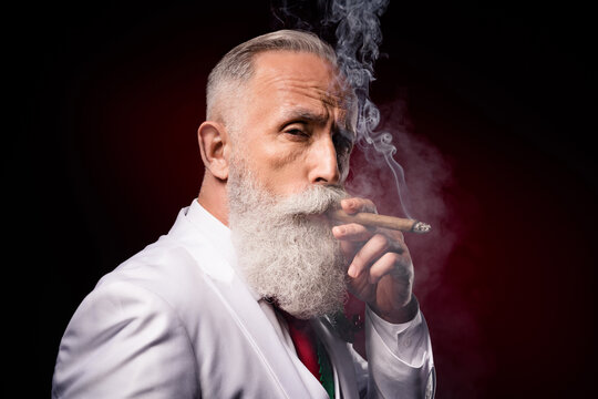 Profile side photo of mature serious man smoke cigar fume nicotine addicted rich isolated over dark color background