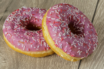 Tasty glazed raspberry donut with topping.