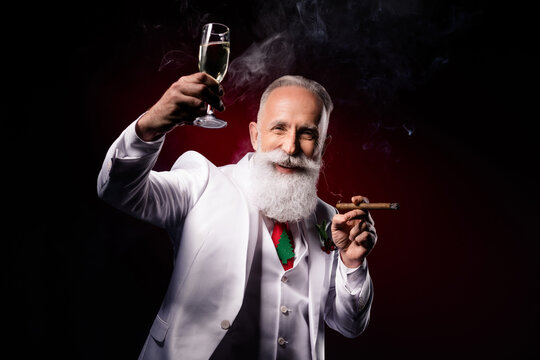 Photo of aged man happy positive smile drink alcohol glass party smoke x-mas isolated over dark color background