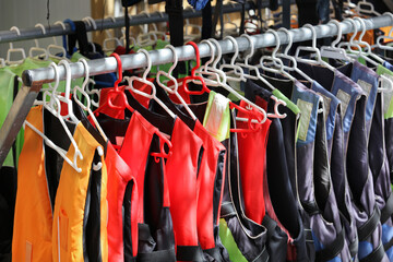 Aquatic rescue vests in coat rack for aquatic activities