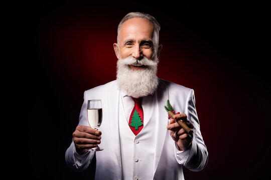 Photo of mature man happy positive smile drink alcohol smoke cigar christmas celebration isolated over dark color background