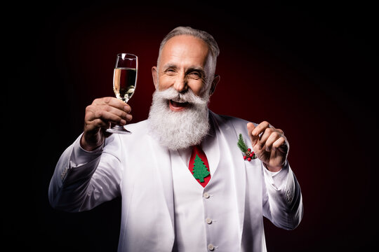 Photo of mature man happy positive smile drink champagne party x-mas holiday isolated over dark color background