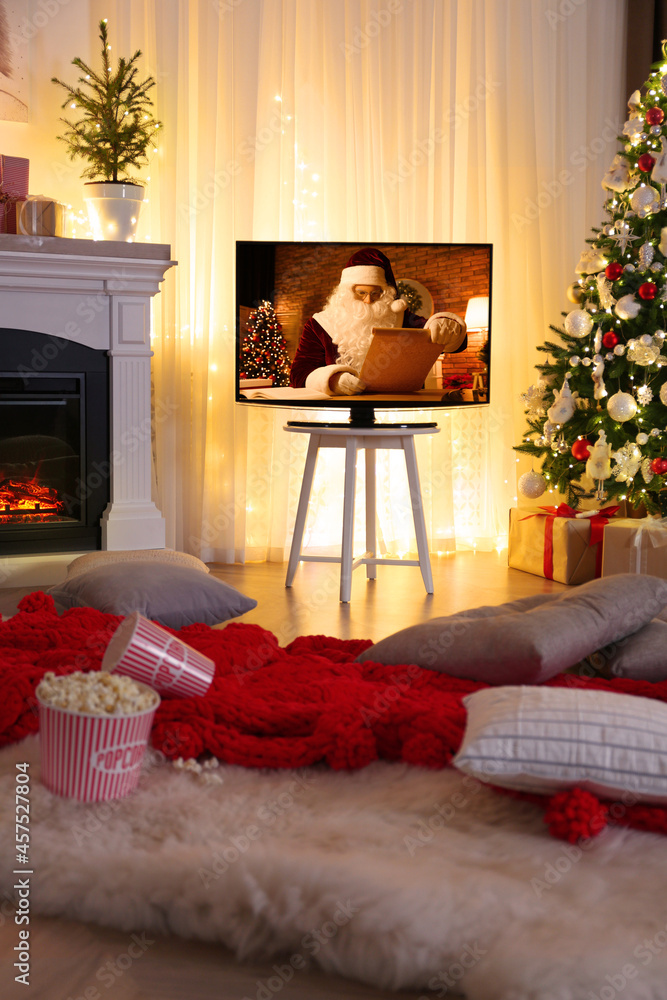 Wall mural Stylish living room interior with TV set, Christmas tree and fireplace