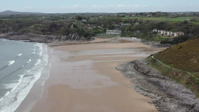 The huge surfing beach of Caswell Bay, on the South Wales Coast Path, at low tide