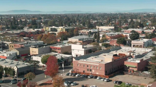 Aerial: Houses and business district in Hayward, Oakland, California, USA