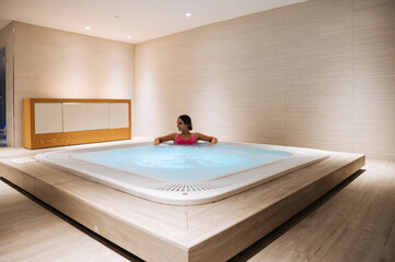 Content woman siting in hot tub