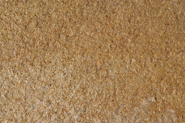 structure of a yellow stone with shiny blotches.