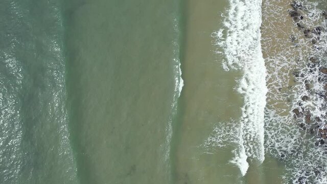 The huge surfing beach of Caswell Bay, on the South Wales Coast Path, at low tide