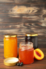Fototapeta na wymiar Homemade fruit jam in the jar on grey background. Top view