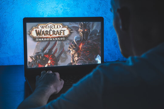 World of Warcraft is a massively multiplayer online role-playing game. Video computer game. Man play video game on laptop