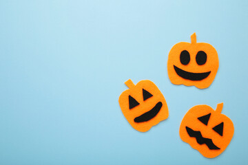 Halloween composition with pumpkins on blue background. View from above.