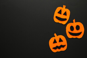 Halloween composition with pumpkins on black background. View from above.