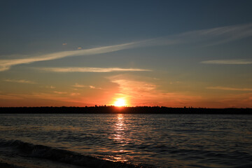 Fototapeta na wymiar Landscape with beautiful sunset over calm river